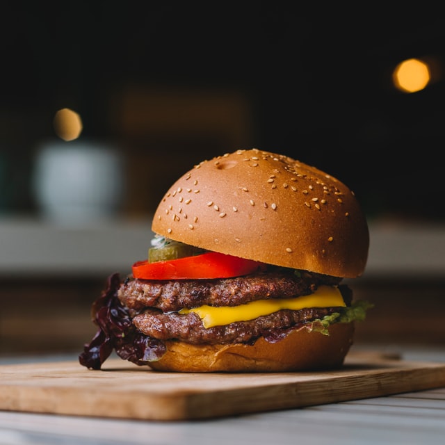 a burger on a cutting board