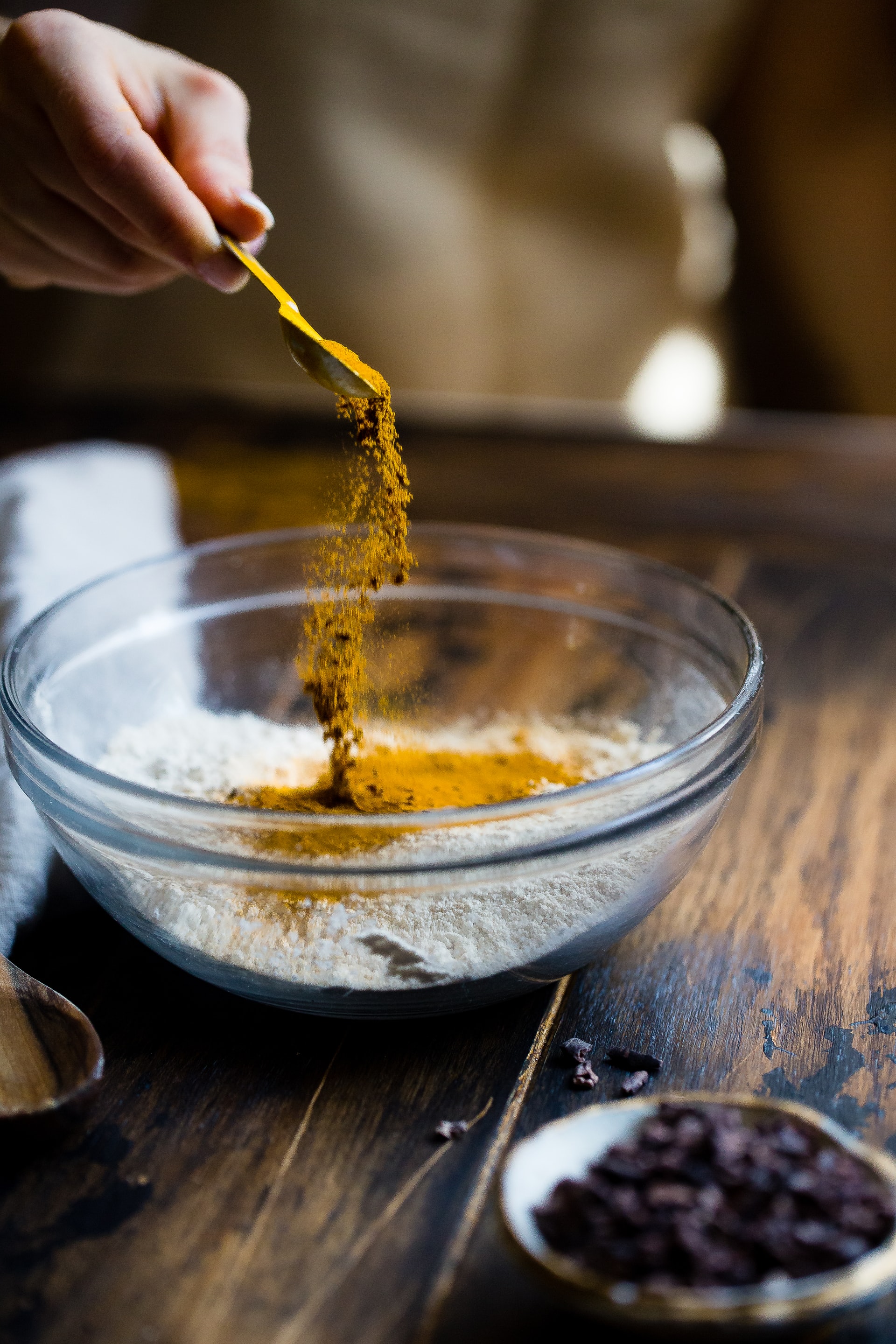 spices being sprinkled on flour